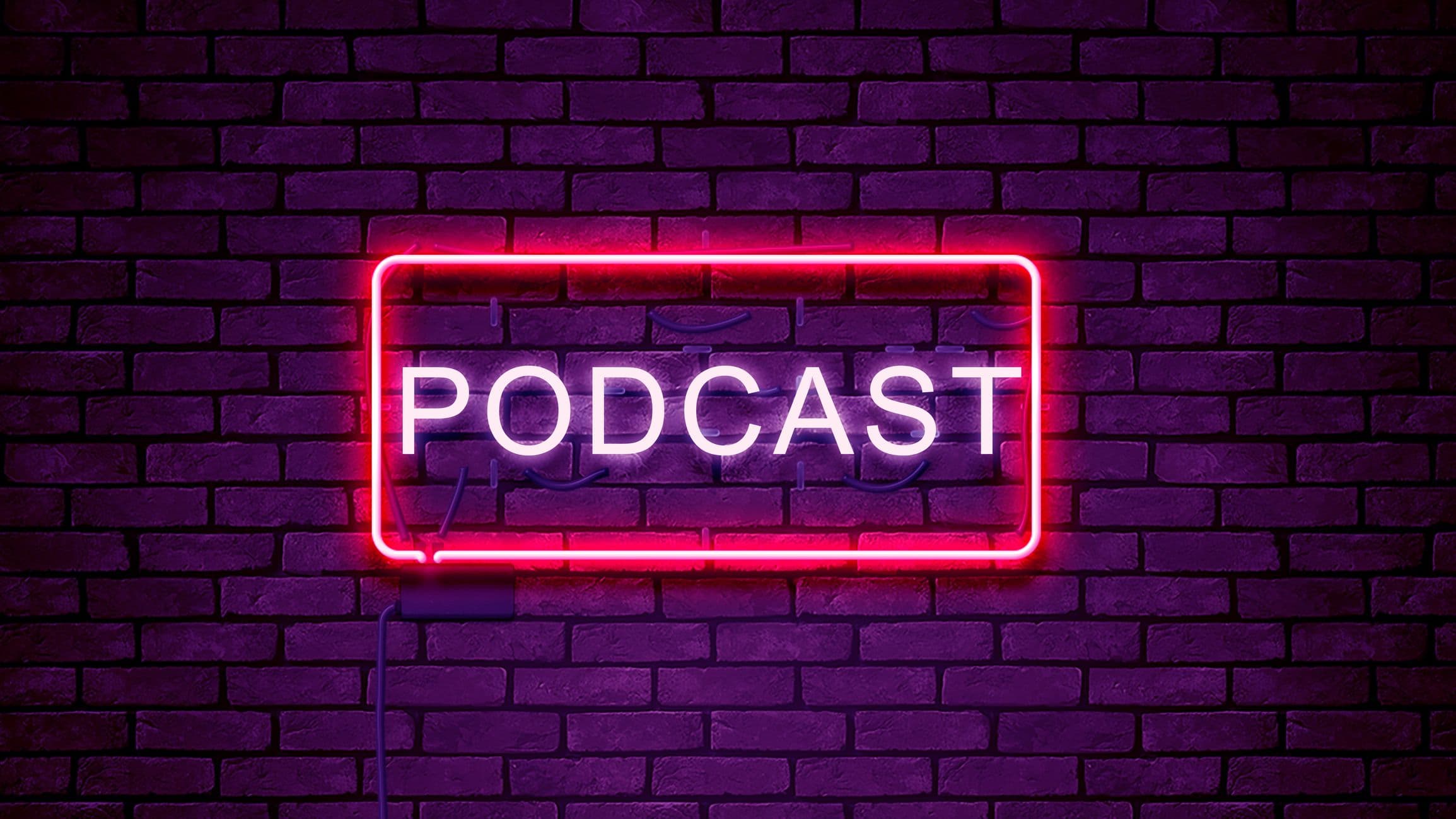 A photo of a neon sign against a brick wall that reads "podcast."