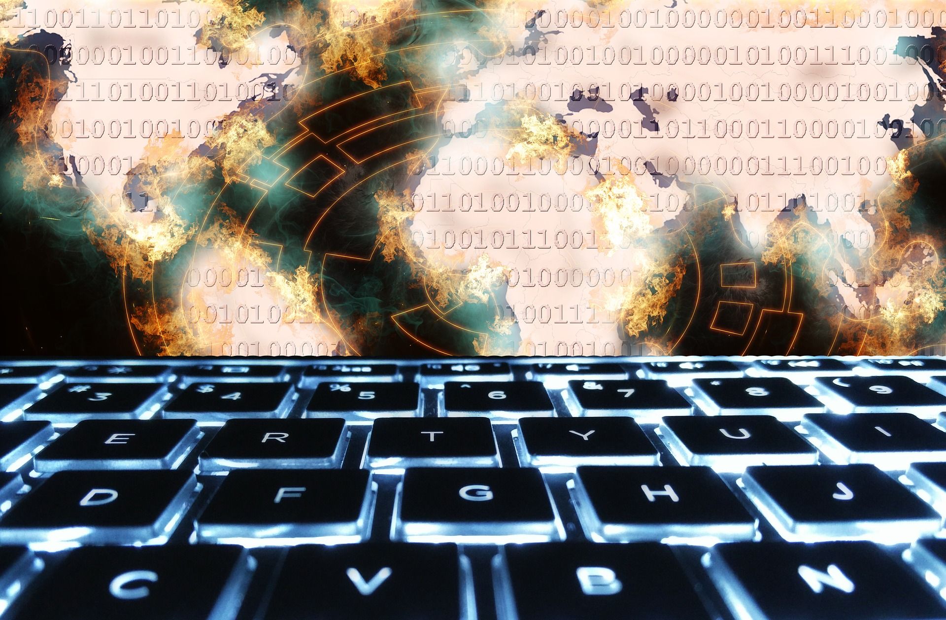 Composite image with glowing keyboard in foreground and explosions with binary code overlay