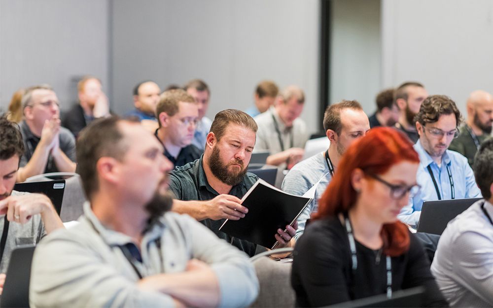 Audience members at CONVERGE 2019 technical lab session with laptops