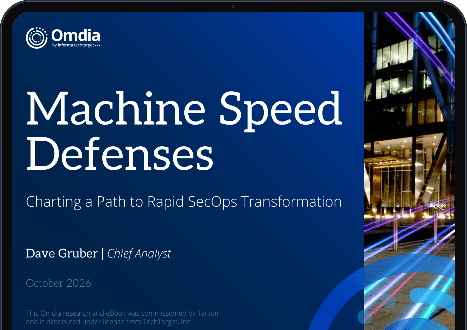 태블릿 화면에 표시된 Omdia 전자책 『Machine Speed Defenses: Charting a Path to Rapid SecOps Transformation』(저자: 수석 애널리스트 데이브 그루버)의 표지